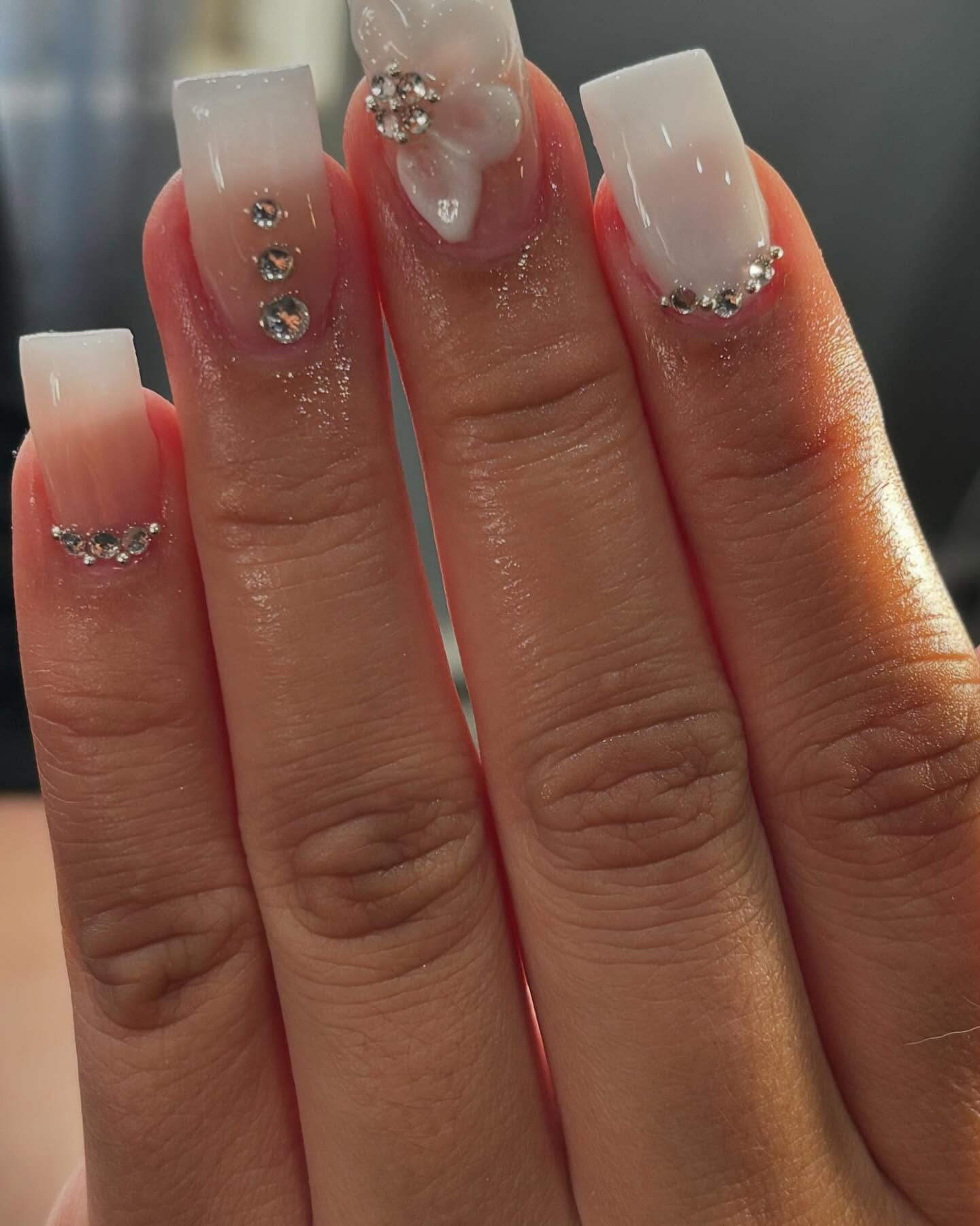 White ombre nails with rhinestone and 3D bow detail